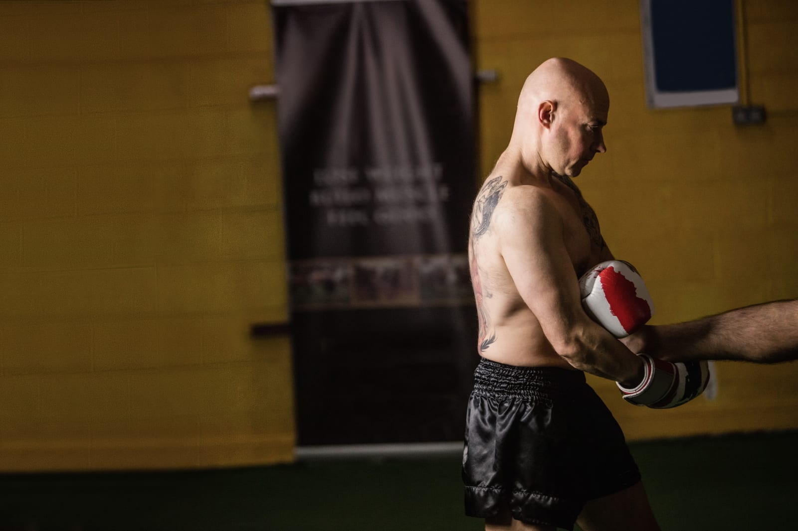 A training partner holding a focus mitt steady for a drill in a Toronto studio.