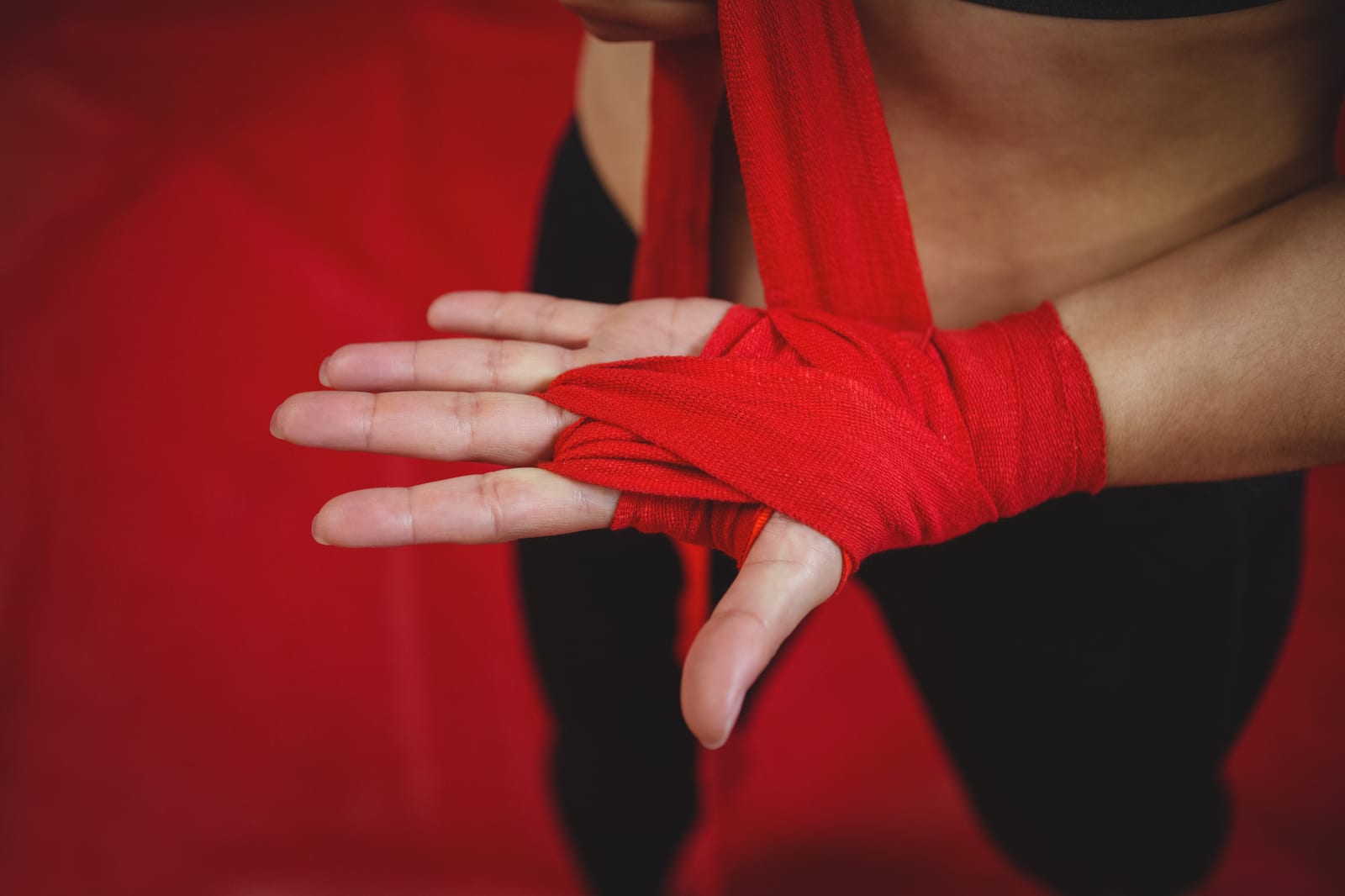 A close-up of a hand wrap being secured before a training round.